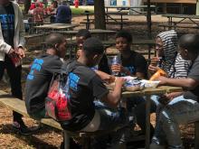 Teens eating at a picnic table