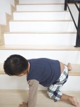 Toddler climbing on stairs.