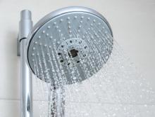 Close-up of the front of a running shower head