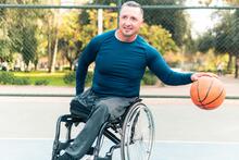 Young adult playing wheelchair basketball