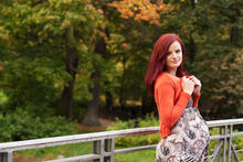 A pregnant adult enjoying autumn colors