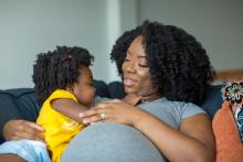 Pregnant cuddling a toddler