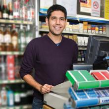 Sales person at checkout counter of store