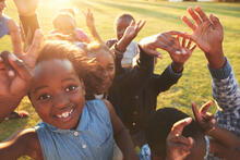 Group of children playing and jumping outdoors