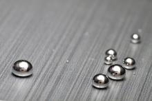 Shiney mercury drops on textured surface