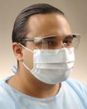 An adult wearing a surgical mask.
