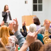 People at a conference listening to a speaker