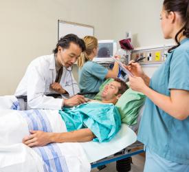 A team of medical staff caring for a patient in a hospital setting